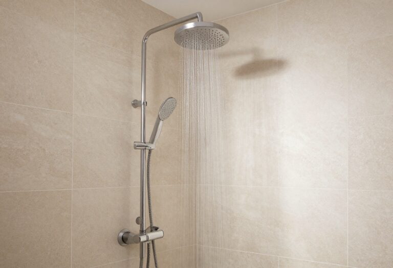 Modern spa-inspired bathroom with rainfall showerhead and natural stone tiles in a bright, serene setting.