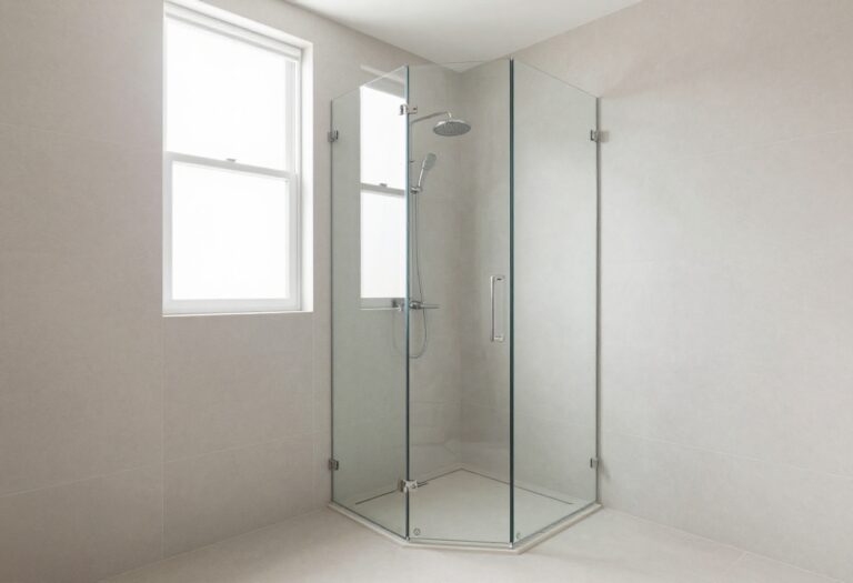 A modern doorless stand-up shower in a bright bathroom with clean design and natural light, showcasing an open layout to upgrade space.