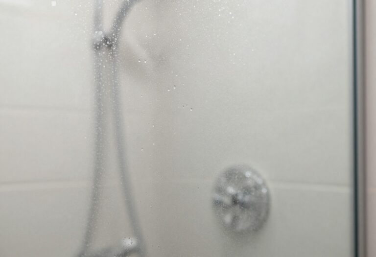Sparkling clean glass shower door with water droplets