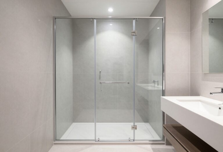 Small bathroom with glass corner shower and floating vanity