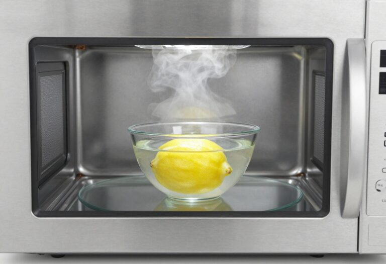 Clean microwave interior with a bowl of lemon water and steam