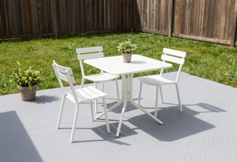 Patio with painted concrete floor and stenciled pattern, bistro table, and potted plant
