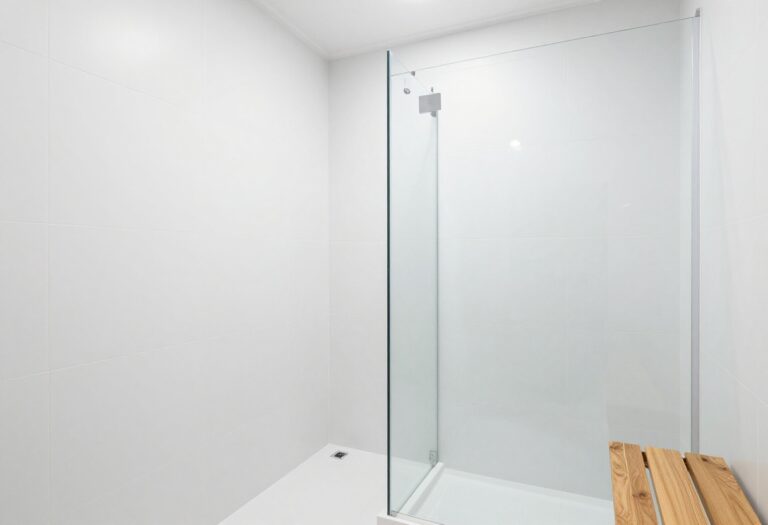Modern shower with large white tiles and glass enclosure